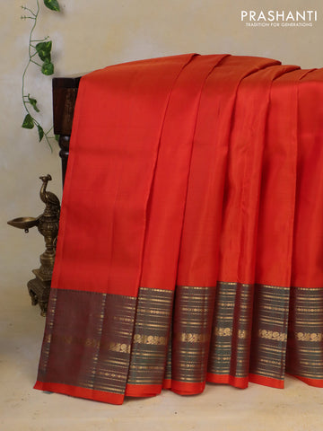 Pure kanchipuram silk saree orange and dual shade of teal green with plain body and rich zari woven border