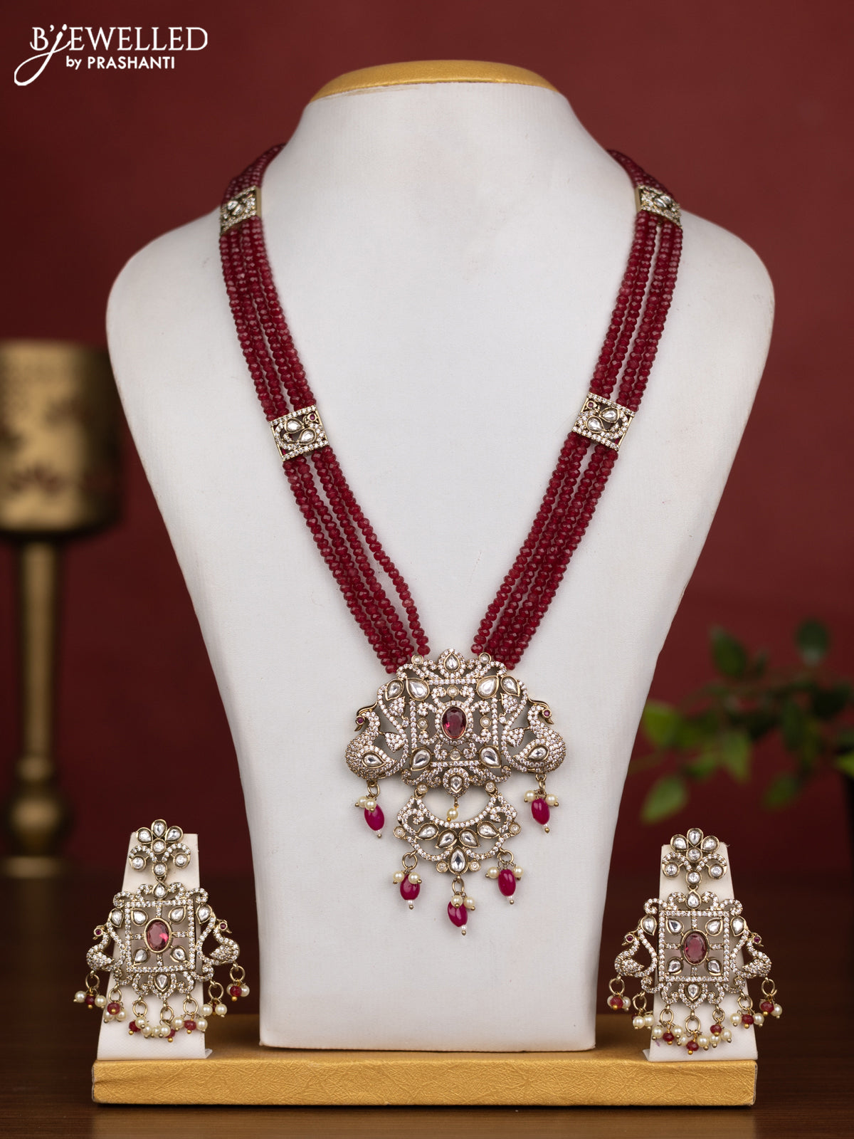 Beaded multilayer maroon necklace with ruby kundan & cz stones and pearl & beads hanging in victorian finish