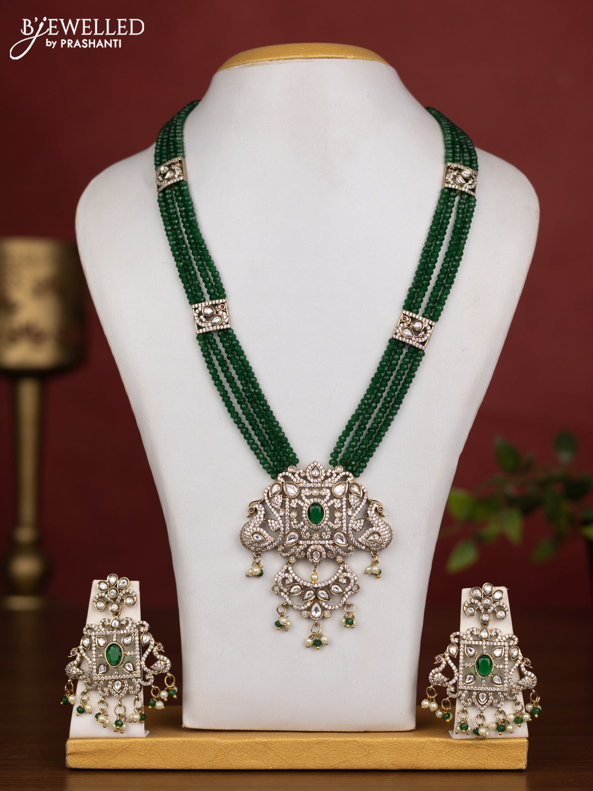 Beaded multilayer green necklace with emerald kundan & cz stones and pearl & beads hanging in victorian finish