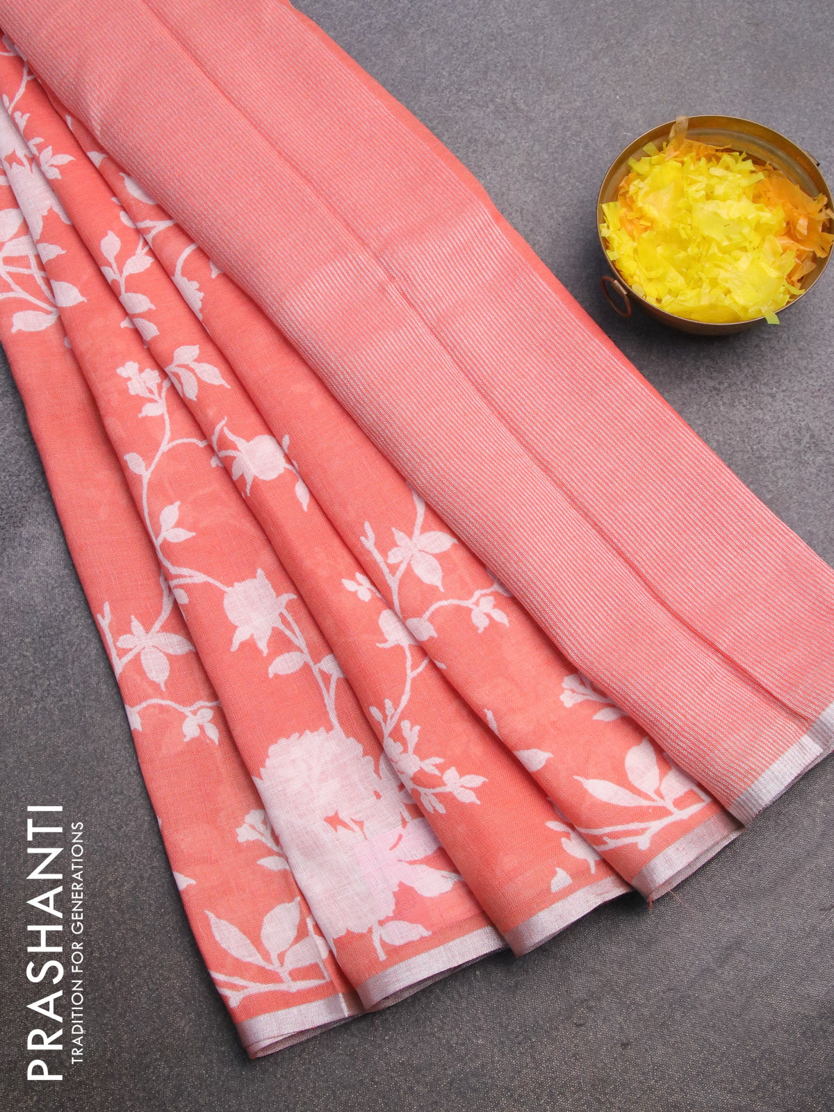 Pure linen saree peach orange with allover floral prints and silver zari woven piping border