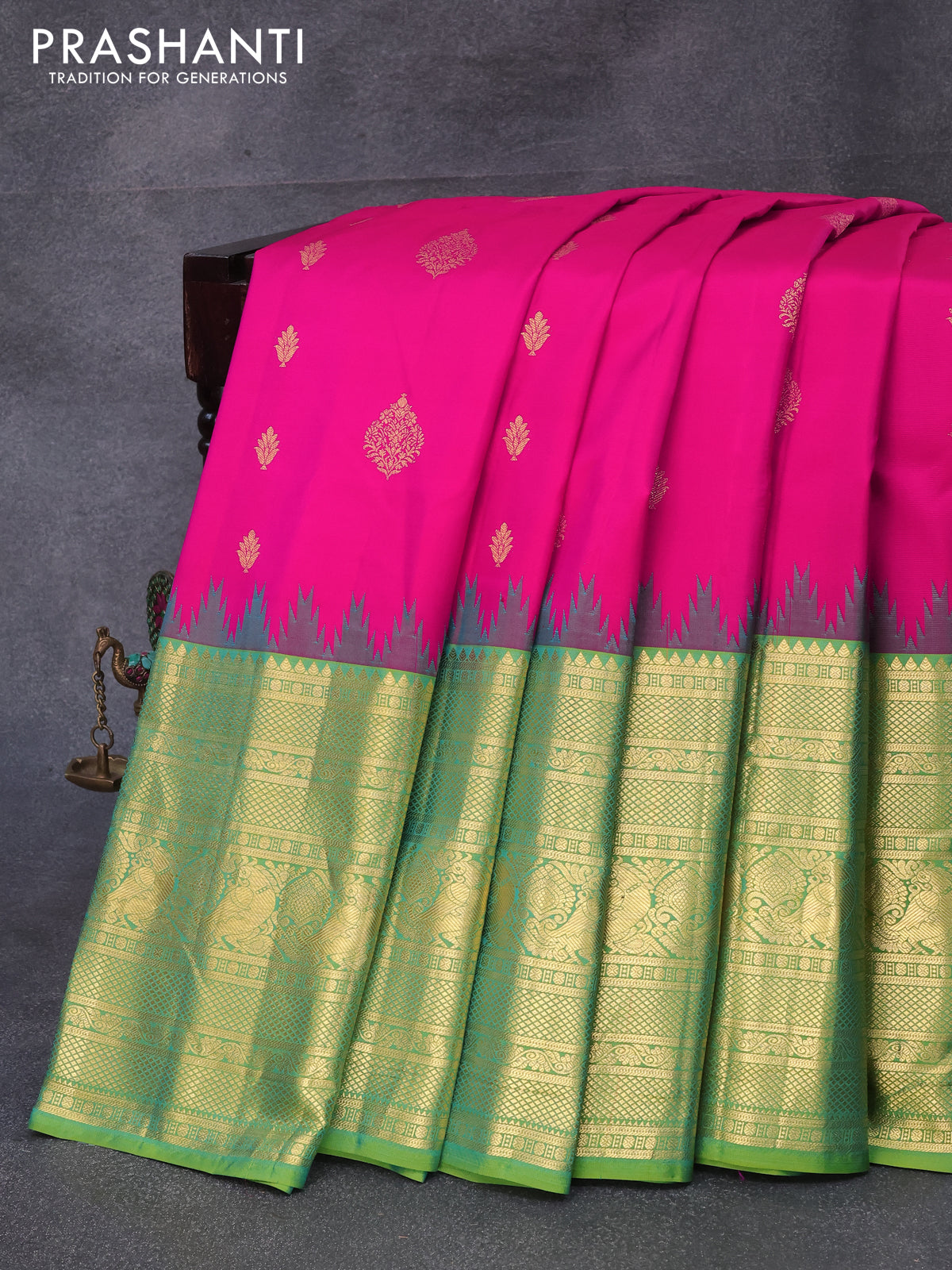 Pure gadwal silk saree pink and green shade with zari woven floral buttas and temple design long zari woven border