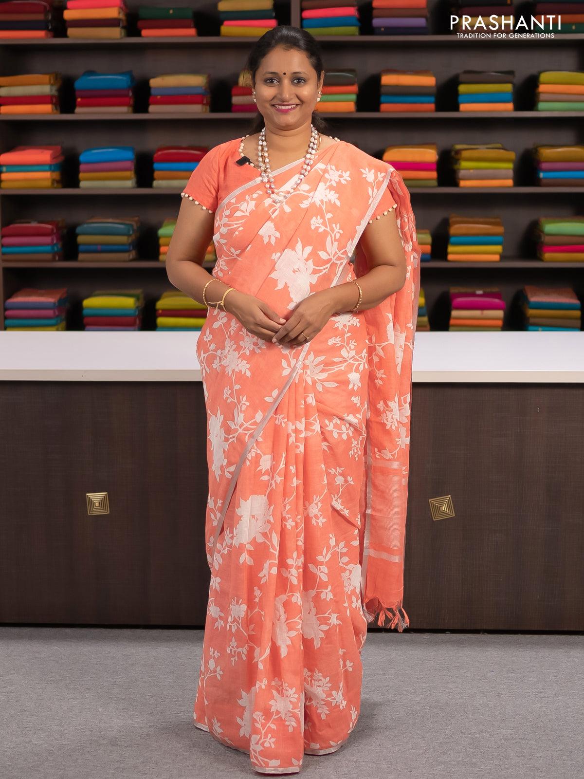 Linen cotton saree peach orange with allover floral prints and small silver zari woven border