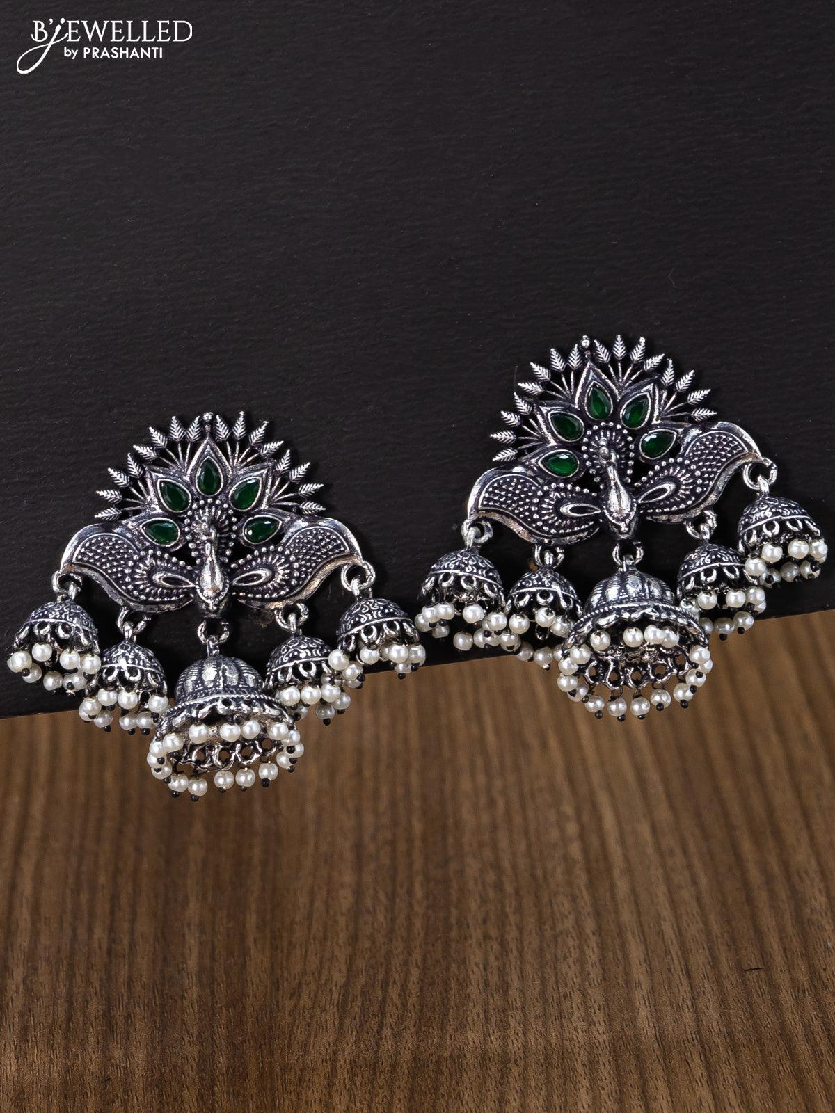 Oxidised jhumka peacock design with emerald stones and pearl hangings