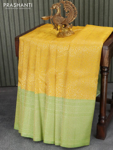 Pure Kanchivaram silk saree yellow and light green with allover floral zari weaves and zari woven border
