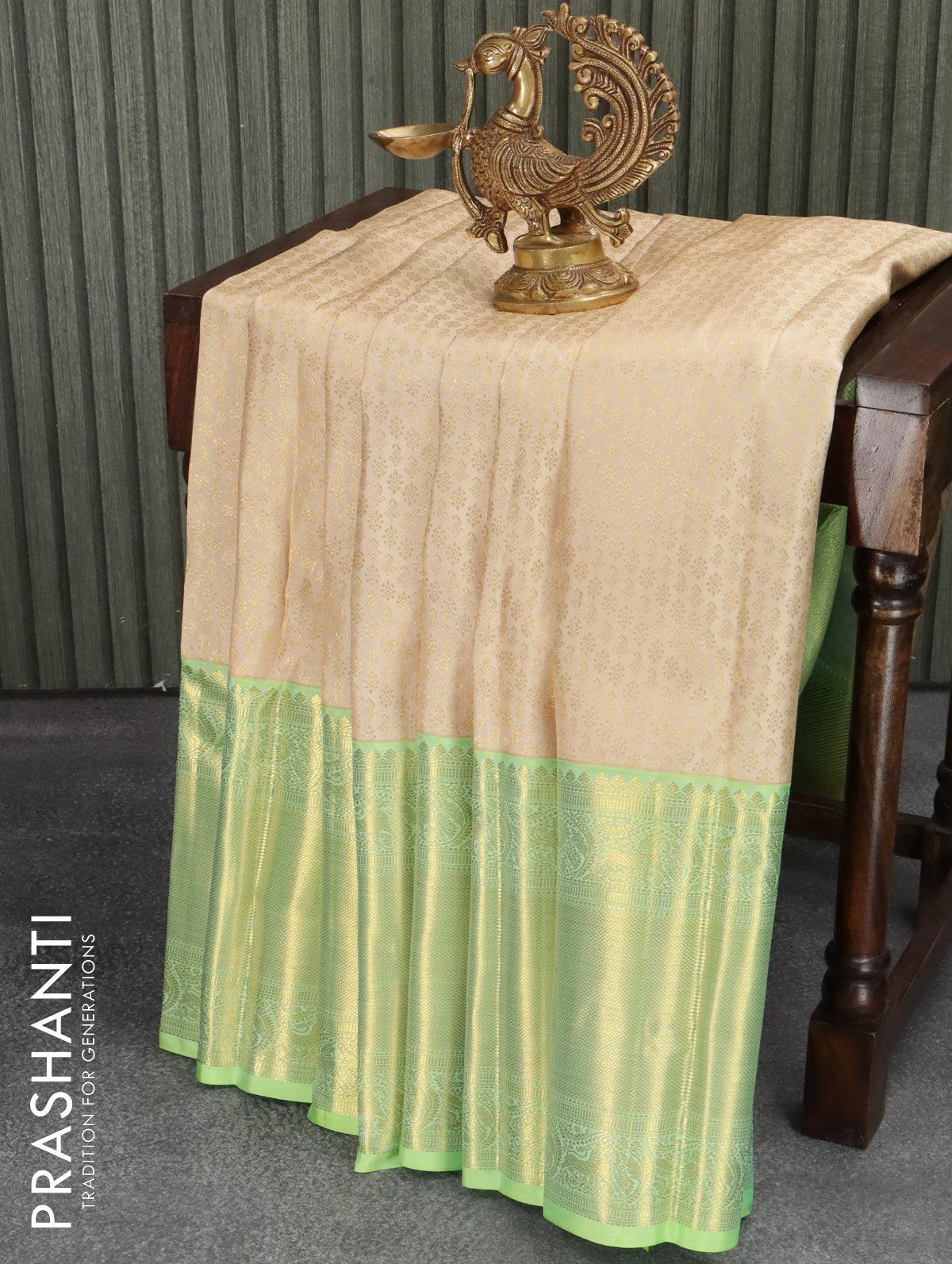 Pure kanjivaram silk saree cream and light green with allover zari weaves and long rich zari woven border